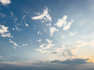 Golden sunlight streams through the edge of the horizon in this serene sky photograph, captured during early morning or late evening.