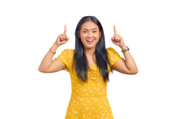 Smiling young Asian woman pointing fingers up at copy space isolated on transparent background