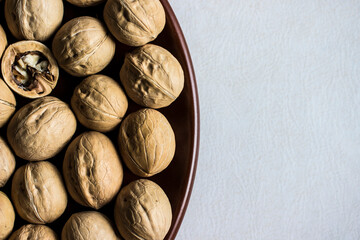 walnuts on a brown plate. close-up. a place for a text