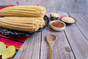 Ready-to-eat corn on the cob prepared with mayonnaise, cheese, and spicy chili, Mexican food