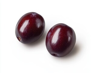 Obraz premium Two Ripe Dark Red Plums on White Background