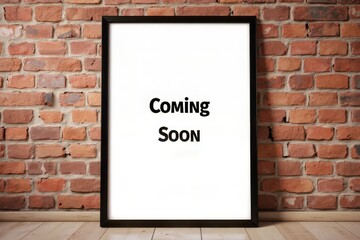 Empty black framed picture against a brick wall.