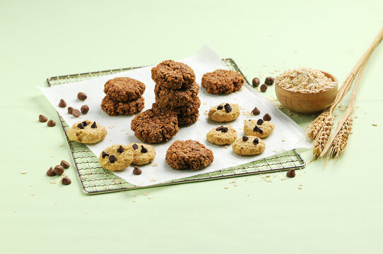 chocolate oatmeal cookies and choco chip oatmeal cookies on baking paper on a cooling rack