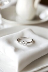 Elegant Diamond Engagement Ring Close-up on White Napkin in Soft Light for Wedding Proposal Romance