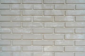 Close-up of a white painted brick wall with a rough texture and horizontal pattern, ideal for backgrounds or architectural design concepts
