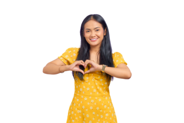 Smiling young Asian woman showing heart gesture with two hands and looking at camera isolated on transparent background