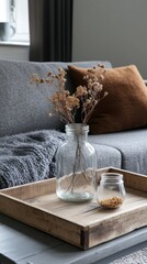 Still Life of Dried Flowers in Glass Vases on Wooden Tray in Cozy Living Room Interior Design