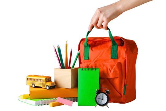 A hand reaches for an orange backpack among vibrant school supplies, isolated on white, PNG