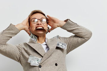 excited man with glasses in beige jacket hold cash currency celebrate success smiling studio white...