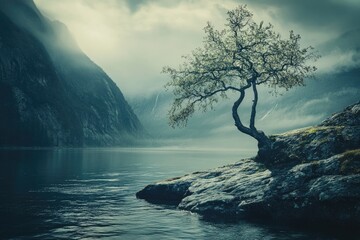 Misty mountain lake with lone tree