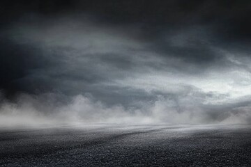 Empty asphalt road under a dark, stormy sky. Foggy atmosphere
