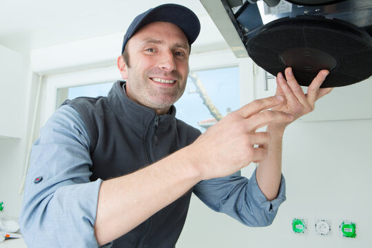 confident handyman fixing kitchen issue