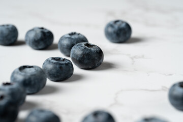 Blueberries Arranged on White Marble Background