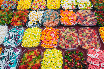 sweets marmalade and chewable candies on the counter at candy store in the oriental market
