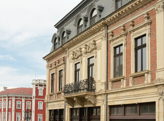 Facade featuring Neo Renaissance pilasters and Neo Baroque stone carvings beneath a slate mansard...