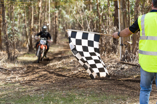 Chequered flag being waved at the end of a motorbike race