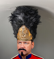 A imperial grenadier wit tall hat - bearskin stands under a low ceiling