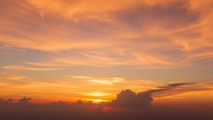 Fototapeta premium Fiery sunset sky with dramatic cloudscape and warm colors