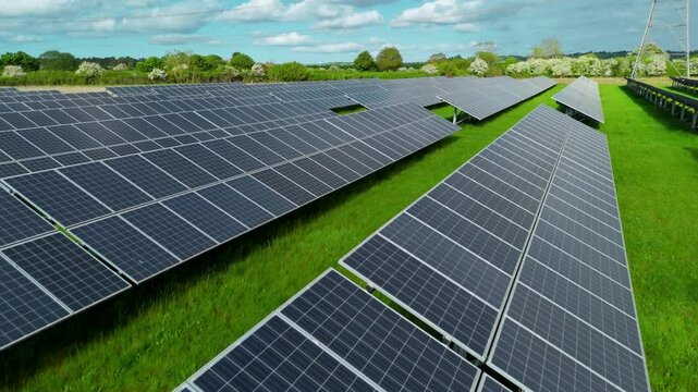 Aerial drone solar power station renewables gas coal fossil fuels Electricity generation Agri voltaic trainline railway closeup rural fields England UK
