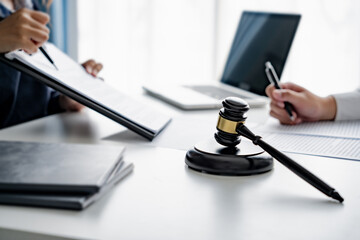 Lawyer with lawsuit meeting with client discussing with contract agreement at law firm