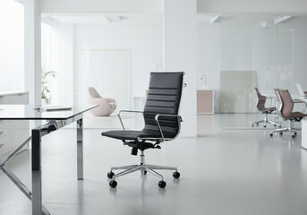 Glass table in modern office with empty chairs.
