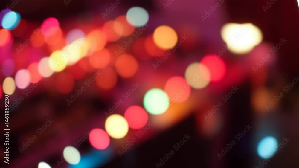 Poster a video showing vibrant blurred lights shining in darkness creating an abstract and colorful spectac