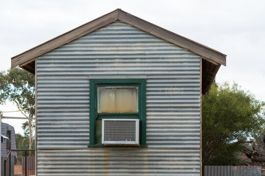 Corrugated iron building with air-conditioning unit in window