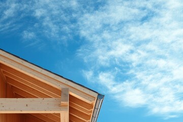 Obraz premium Wooden house under construction against a partly cloudy sky