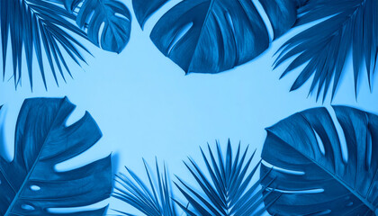 Fototapeta premium Tropical leaves in vibrant blue color create stunning foliage arrangement against soft blue background, evoking serene and calming atmosphere