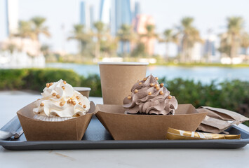 Creamy and chocolate cupcake decorated with golden balls, cup cakes with whipped cream