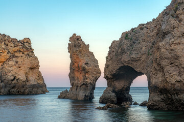 Punta da Piedade cliffs in the Algarve region of Portugal at dusk.
