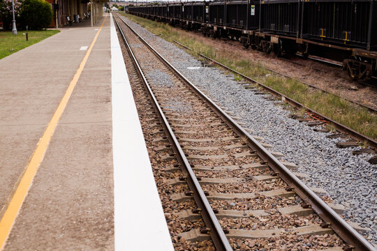 Railway track, platform and railway trucks at Harden railway station