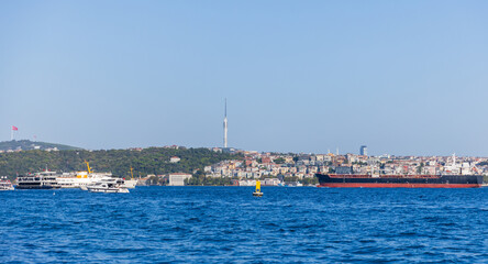 Fototapeta premium Bosporus scene featuring various vessels, coastal urban architecture