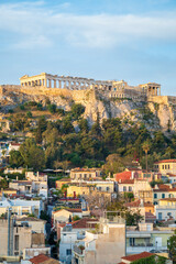 View of the Acropolis, in Athens, overlooking the old city, as the early morning light illuminates the buildings and the Parthenon