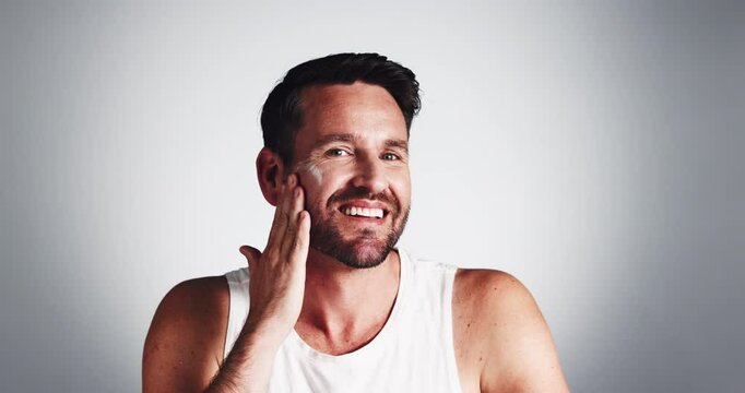 Man, skincare and happy with cream on face for skin hydration, morning routine and spf protection. Mockup, person and apply lotion product for self care, grooming and dermatology on studio background