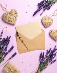 A vibrant bunch of fresh lavender flowers in full bloom, accompanied by two elegant, vintage-style envelopes resting nearby, creating a serene, inviting scene.