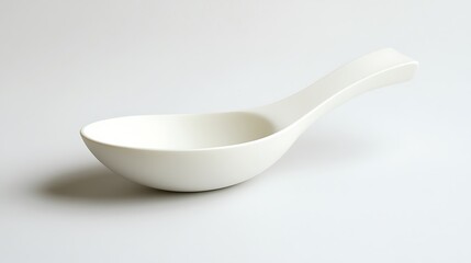 White ceramic spoon with minimalist design.