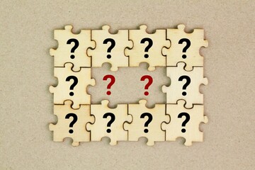 wooden puzzle with a question mark symbol. Concept of question, FAQ, Q and A, confusion and...