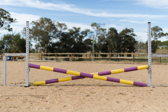 Timber jump set up for show jumping in a sand arena