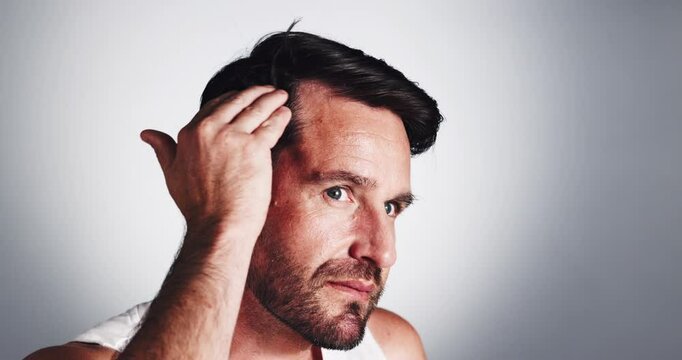 Man, hairline and oil with dropper for scalp condition, hair growth or treatment on a white studio background. Male person, model or applying serum with pipette for dry, alopecia or texture on space