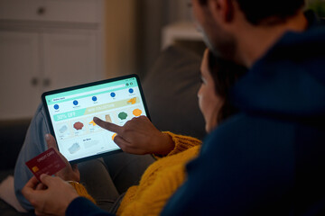 Romantic Couple's Online Shopping Adventure. Joyful couple shopping online, embracing technology and love at home.
