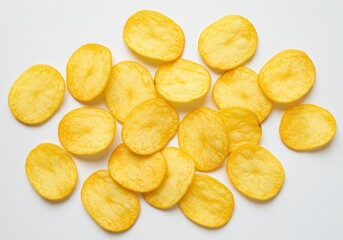 Pile of golden potato chips scattered on a white surface ready to be eaten