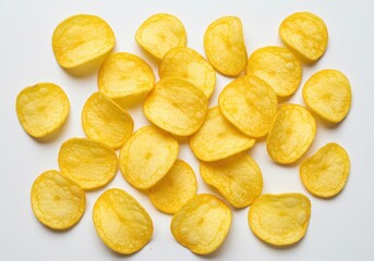 Pile of crispy potato chips scattered on a white surface ready to be eaten