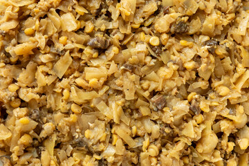 Sauerkraut with yellow peas and dried forest mushrooms, background texture. Polish Christmas Eve cuisine. 