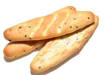 Cookies shaped like baguettes lie on a white background. Close-up.