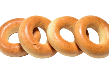 Fresh baked goods and pretzels for tea lie in a pile on a PNG background.