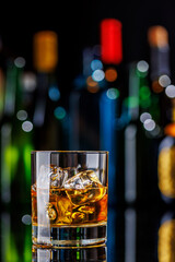 Whiskey on the rocks on a bar table
