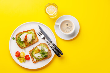 Delicious avocado toasts topped with perfectly cooked poached eggs