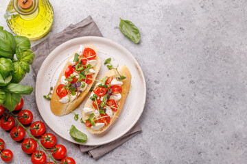 Tasty antipasto toasts featuring classic caprese with mozzarella and tomatoes, and savory prosciutto with herbs