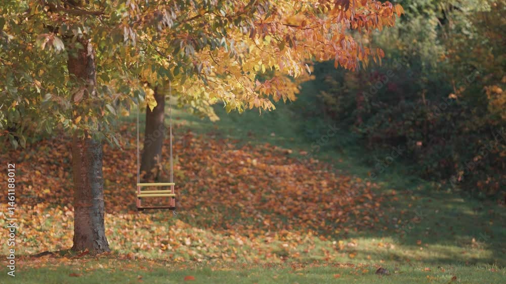 Poster a rustic handmade swing hangs still beneath a canopy of colorful leaves on a serene fall afternoon. 